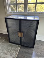 Front view of closed cabinet under window