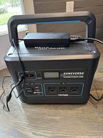 Front view showing AC adapter on top, LCD display and all input/output ports