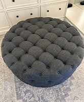 Top-down view showing round tufted cushion surface