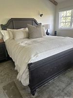 Assembled Cal King bed frame with linens and pillows in bedroom