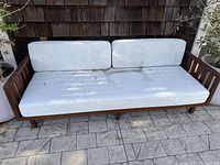 Front view of wooden frame and white cushions