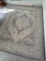 Full overhead view of rectangular area rug on tiled floor