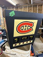 Front angled view of Montreal Canadiens-themed jumbotron scoreboard showing team logo, digital time 12:45, and score 2-1