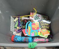 Top view of box with sticker albums, paper crafts, and craft rolls