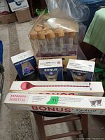 Photo showing various barware including glass test tubes, cocktail spoon, plastic wine glasses, and boxed espresso martini glasses