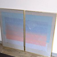 Both diptych panels displayed upright leaning against a wall showing the full design and brass frames.