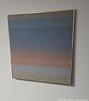 Front view of framed artwork with pastel ombre stripes and brass frame