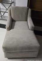 Front view of the grey microfiber chaise lounge chair showing cushion and armrests.