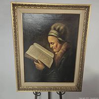 Full view of framed reproduction painting on stand