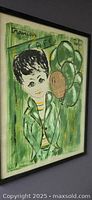 Framed vintage mixed-media collage art of a boy holding balloons with green and yellow tones on paper.