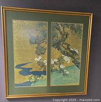 Front view of the framed print showing the two-panel artwork depicting a textured tree branch, chrysanthemums, a blue stream, and gold patterned background.