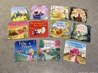 Top view of all 11 mini books laid out showing colorful illustrated covers and titles.