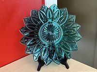 Front view of Federal Glass teal blue petal plate showing flower petal embossing and radiating center design