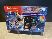 Front view of the sealed box showing astronaut, planets, solar system diagram and titles
