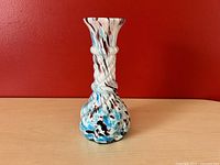 Front and full view of vintage speckled glass vase showing shape, color pattern, and collar ring detail