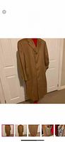 Front view of camel-colored full length cashmere coat on hanger.