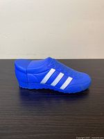 Blue Adidas-style shoe-shaped bottle containing Wild Country aftershave