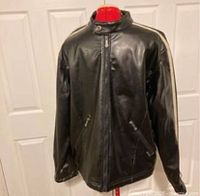 Front view of black leather moto jacket with front zippered pockets and zipper closure, displayed on a mannequin.