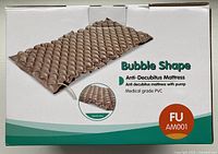 Box showing brown bubble shape mattress image with label 'Anti-Decubitus Mattress with pump' and 'Medical grade PVC'. Model: FU AM001