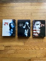 Front covers of 24 DVD box sets for Seasons 1, 2, and 6 featuring Kiefer Sutherland as Jack Bauer.