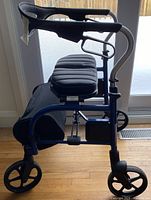 Side view showing padded seat, large front and rear wheels, brake lever and overall frame structure