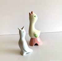 Two ceramic pie birds shown from front and angled view showcasing different colors and features