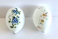 Pair of two Victorian blown glass Easter eggs; one with blue floral hand paint and 'EASTER' inscription, the other with pink cosmos flowers and satin finish