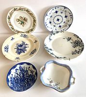 Top view of six plates including rectangular Royal Albert dish and five assorted round plates with floral and blue transfer patterns
