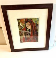 Frontal view of the framed cubist style painting showing the woman with abstract features holding a flower and a white bird perched on her finger.