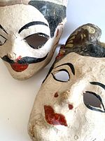 Close-up of both masks showing overall appearance and painted facial details