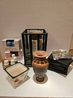 Antique Doulton Silicon Lambeth vase, incense holders, candles, and fragrance oils arranged on surface