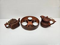 Full set showing tray, 6 cups inside tray, 2 teapots on each side on white background