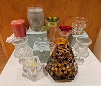 Full set of 12 items including candles, clear and colored rimmed candle holders, and decorative votive holders.