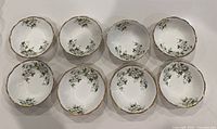 Top view showing the set of 8 white bone china soup/cereal bowls with floral dogwood pattern and gold trim.