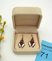 Pair of vintage Southwest style earrings made of 925 sterling silver with polished oval carnelian stones displayed in a light velvet jewelry box.
