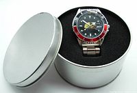 Novelis watch inside silver metal presentation tin, watch in black foam insert