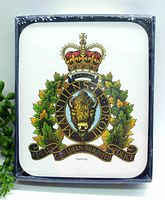 Front view of the coaster set showing the official RCMP badge crest with bison and maple leaves, sealed in clear plastic wrap.