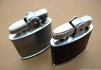 Side view showing the flip top ignition, silver metal body, and brown faux leather wrap on one lighter.