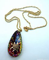 Full view of vintage iridescent teardrop pendant on gold filled chain with lobster clasp, chain laid out flat