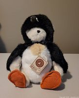 Front view of Boyd's Bears Waddlekins plush penguin showing face, orange feet, and original tag on front.