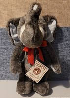 Full view photo of Boyd's Bears plush elephant toy named Skippy with visible red bow and gray fur.