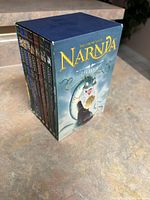 Boxed set of The Chronicles of Narnia books showing front with title and dragon illustration.