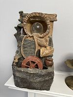 Photo of the small decorative water fountain showing overall structure, materials, and details