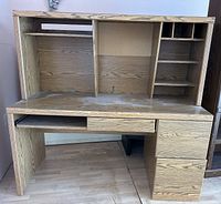 Front view of wooden office desk showing storage shelves and drawers