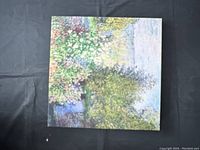 Top down photo of a square canvas wall art showing garden scenery with dense foliage and flowers.