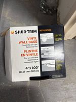 Closed box of Shur-Trim Vinyl Wall Base showing brand, product specifications, and installation illustration.