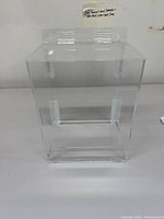 Front-facing view showing the clear acrylic cubbie dispenser with open front for access.