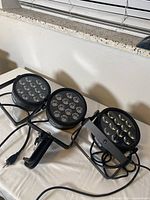 Three Chauvet SlimPAR T12 lights on table with cables