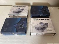 Four unopened E88 drone boxes arranged on a table surface