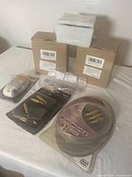 Photo of packaged outdoor wall light fixtures with rechargeable battery and cables arranged on a surface